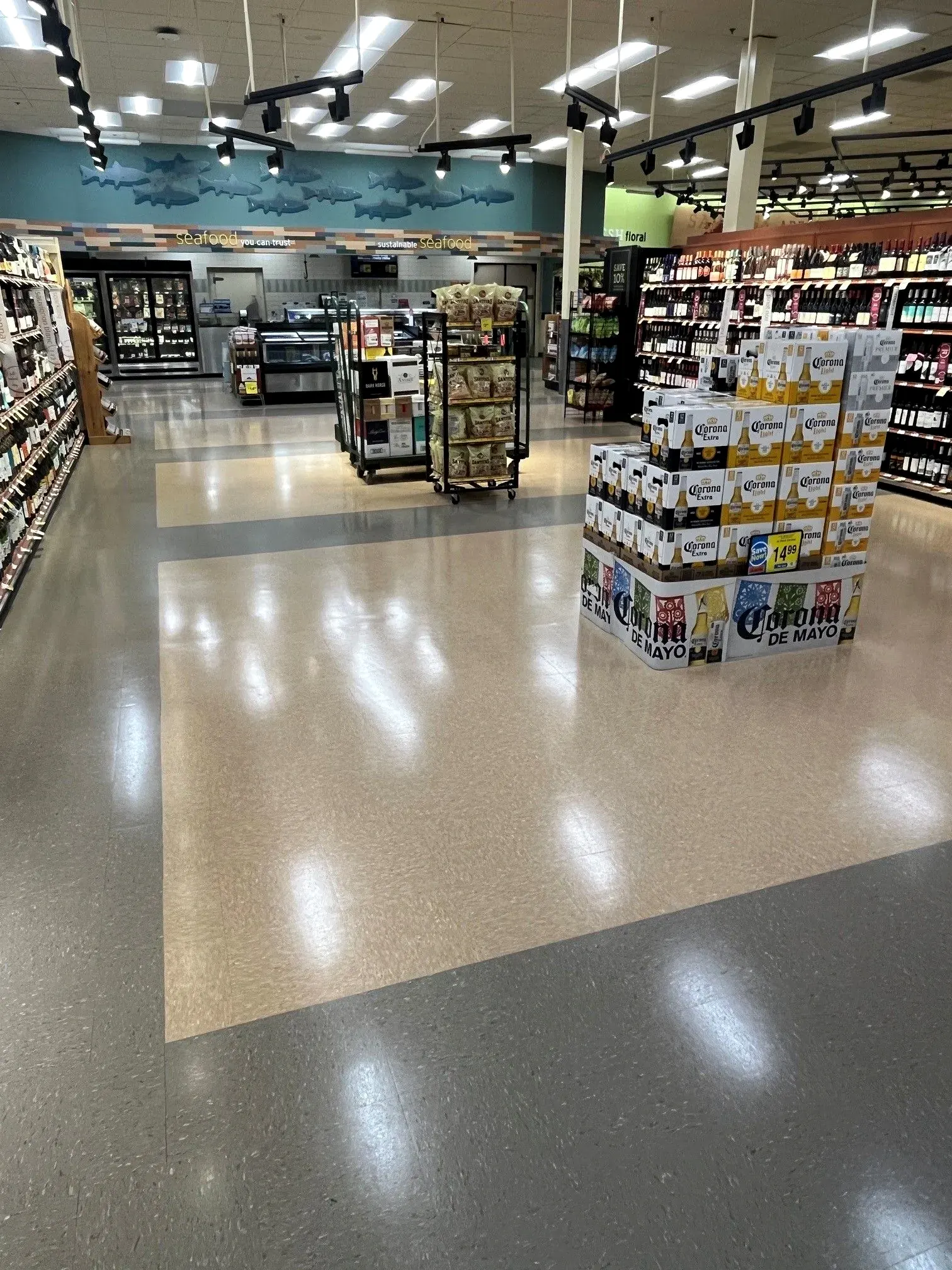 Polished VCT floor with a contrasting inset path in a grocery store