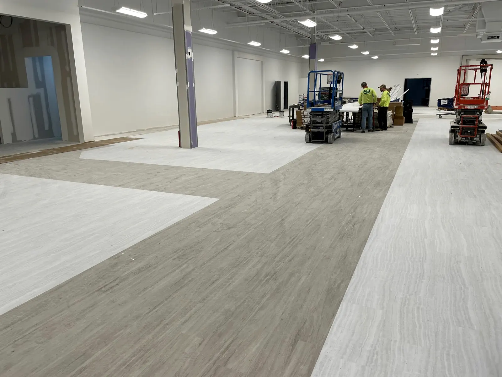 Simeone crew installing plank flooring across an open TJ Maxx store floor