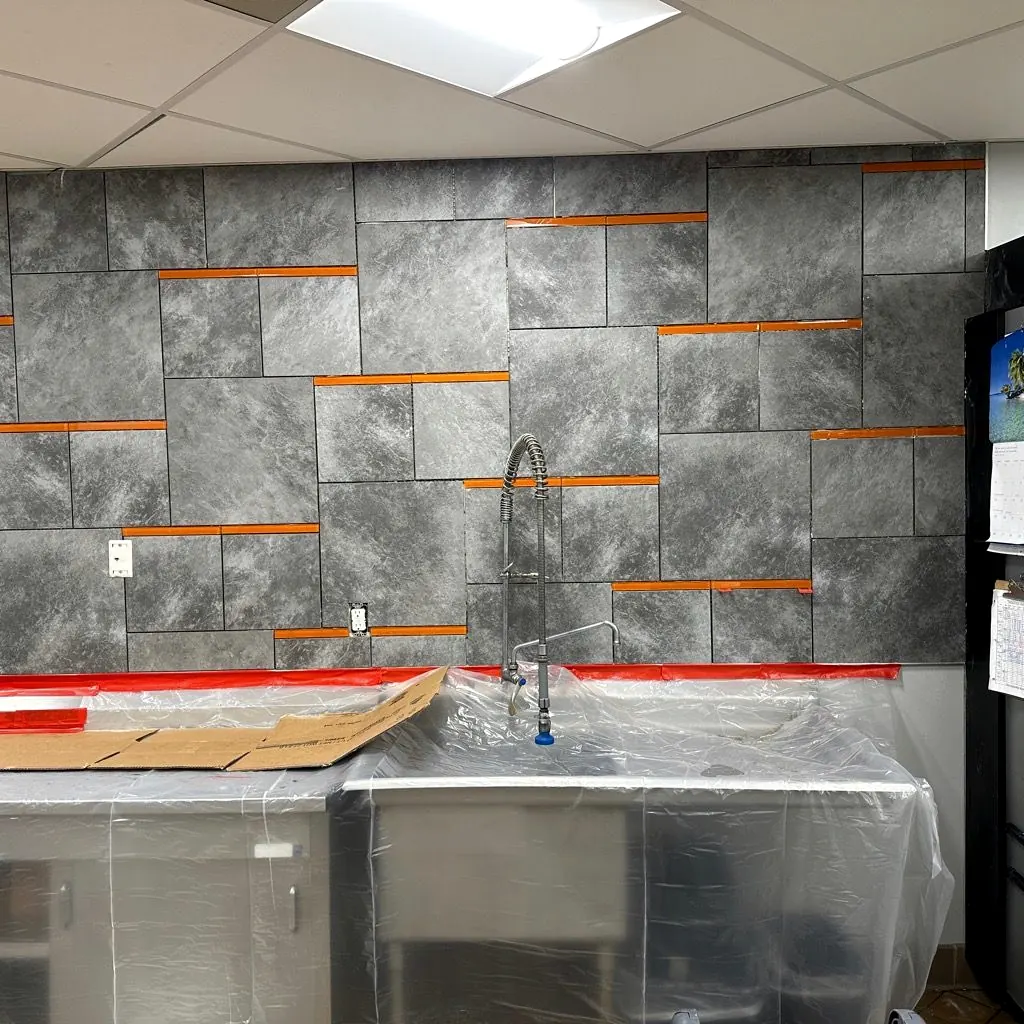 Large gray stone-look wall tile with spacers in a kitchen